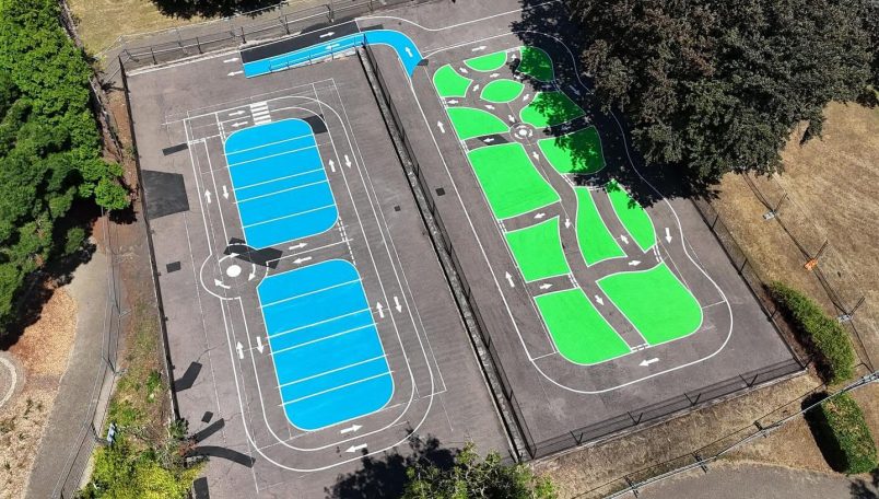 Aerial view of a sports court with blue and green playing areas.