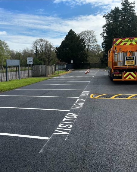 Parking area with a large truck and clear markings for designated spaces.
